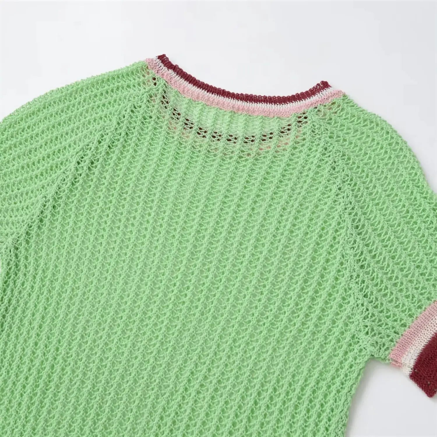 Neckline macro shot, double-layer ribbed collar, mint green inner edge, pink and burgundy outer trim, fine knit stitch detail