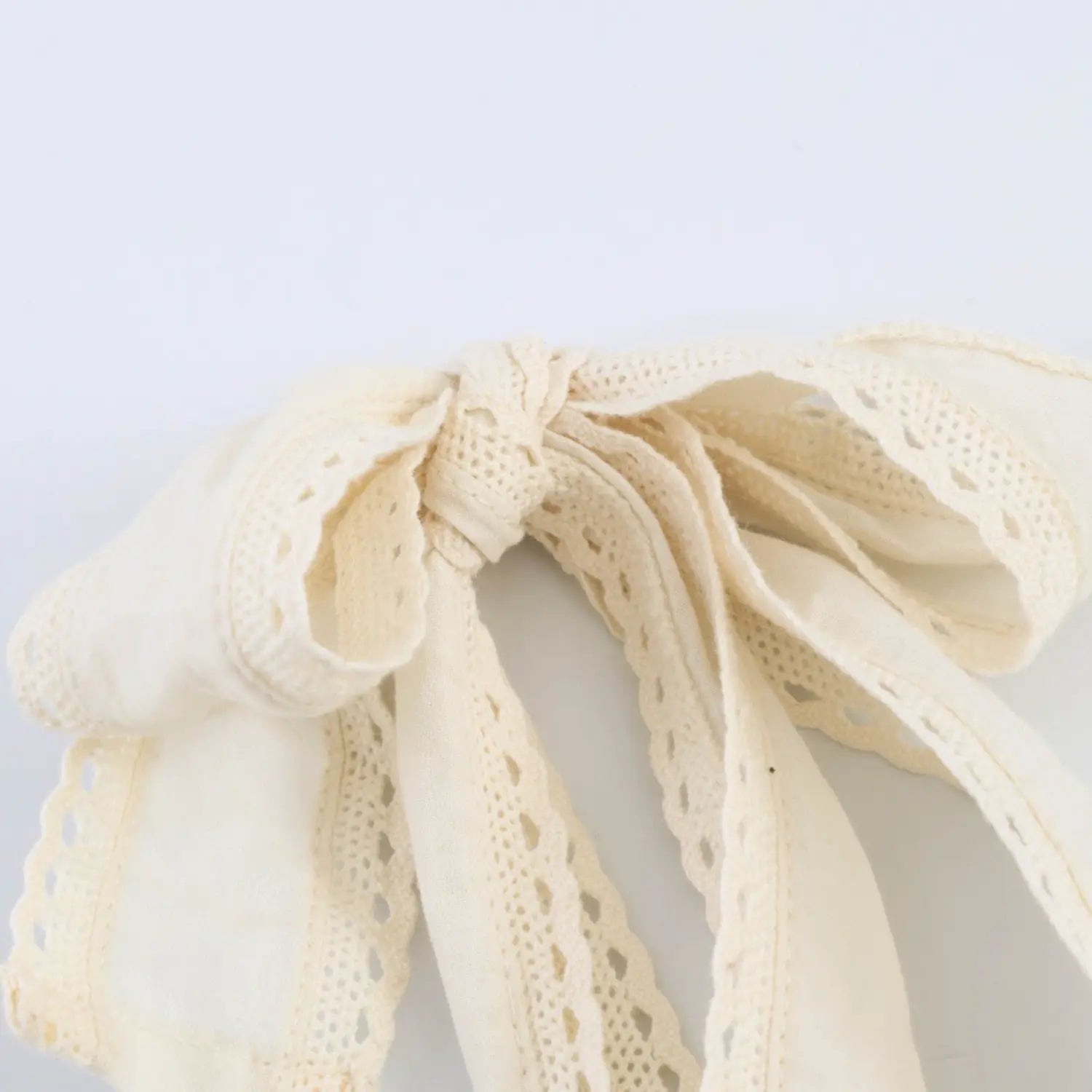 Detail of lettuce ruffle ribbed top edge along square neckline
