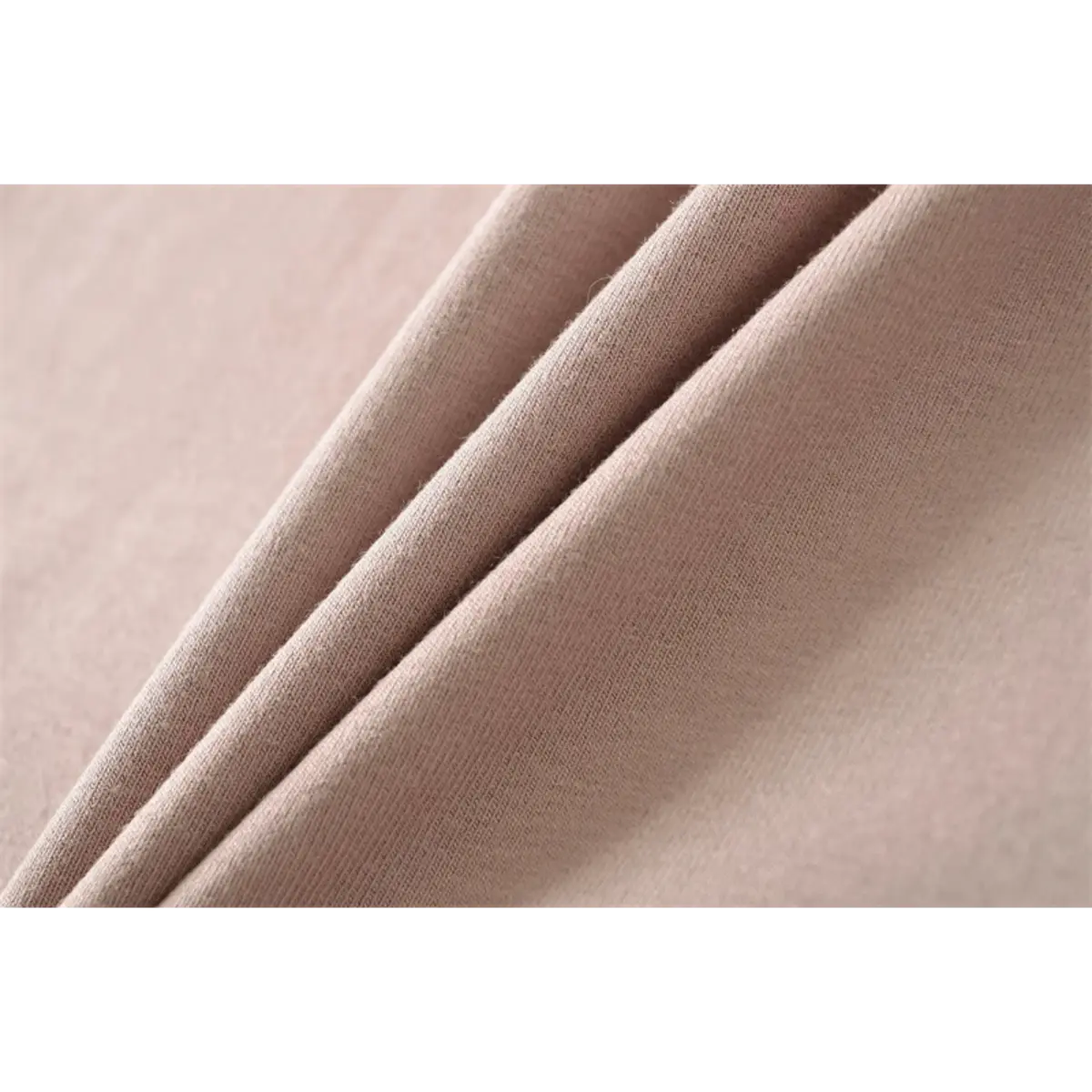 Close-up detail of the smooth, stretchy knit fabric texture on a nude halter-neck mermaid maxi dress.