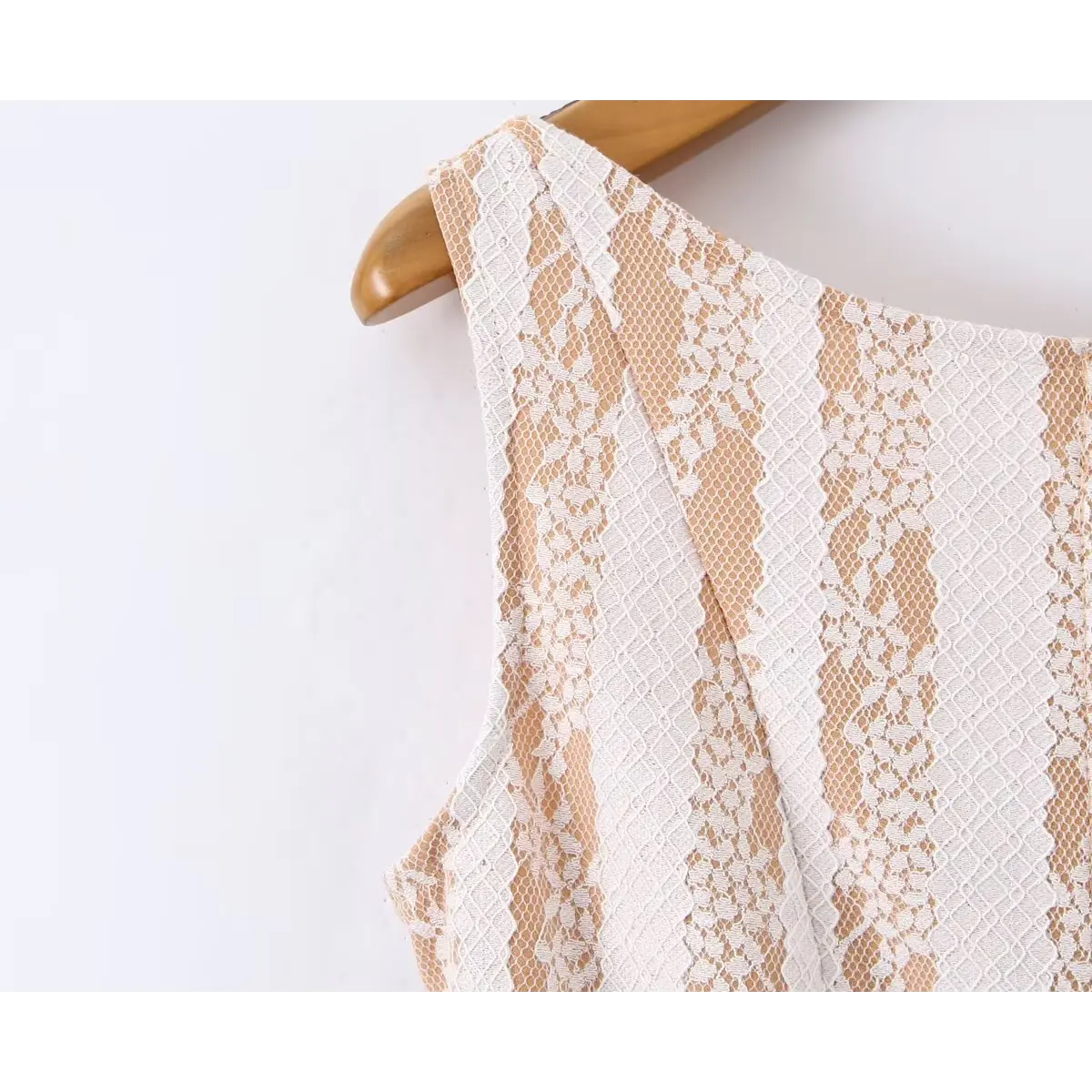 Close-up view of the shoulder strap on a nude lace striped mini dress, showing the floral lace pattern and seam construction.
