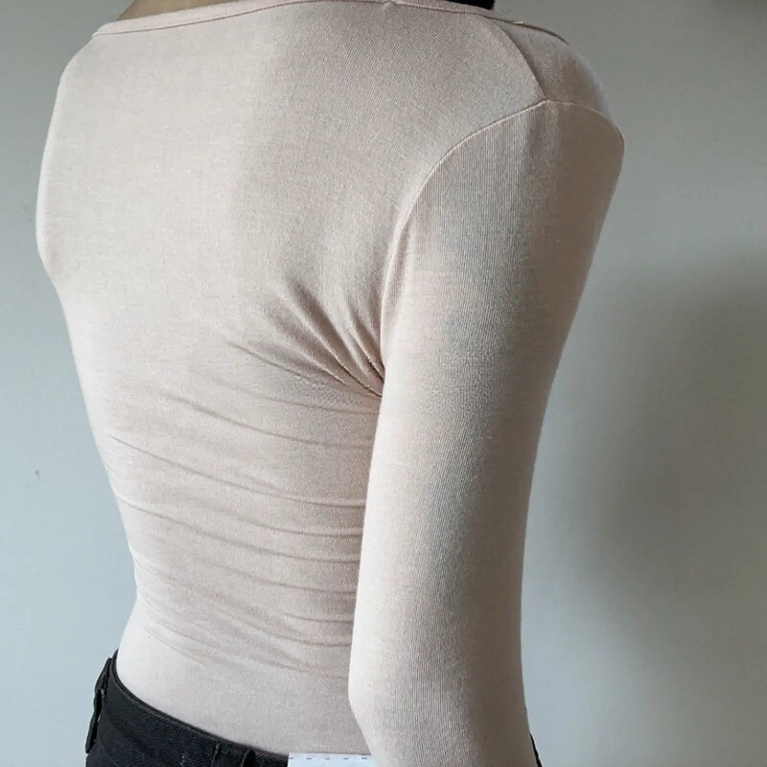 Nude pink fake two piece long sleeve top full back model shot, solid knit plain back natural ruched design simple crew back neck slim cropped fit casual outfit display