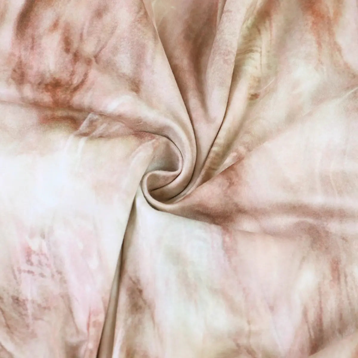 Fabric close-up of the nude tie-dye dress, showing the soft, stretchy texture and muted tie-dye print