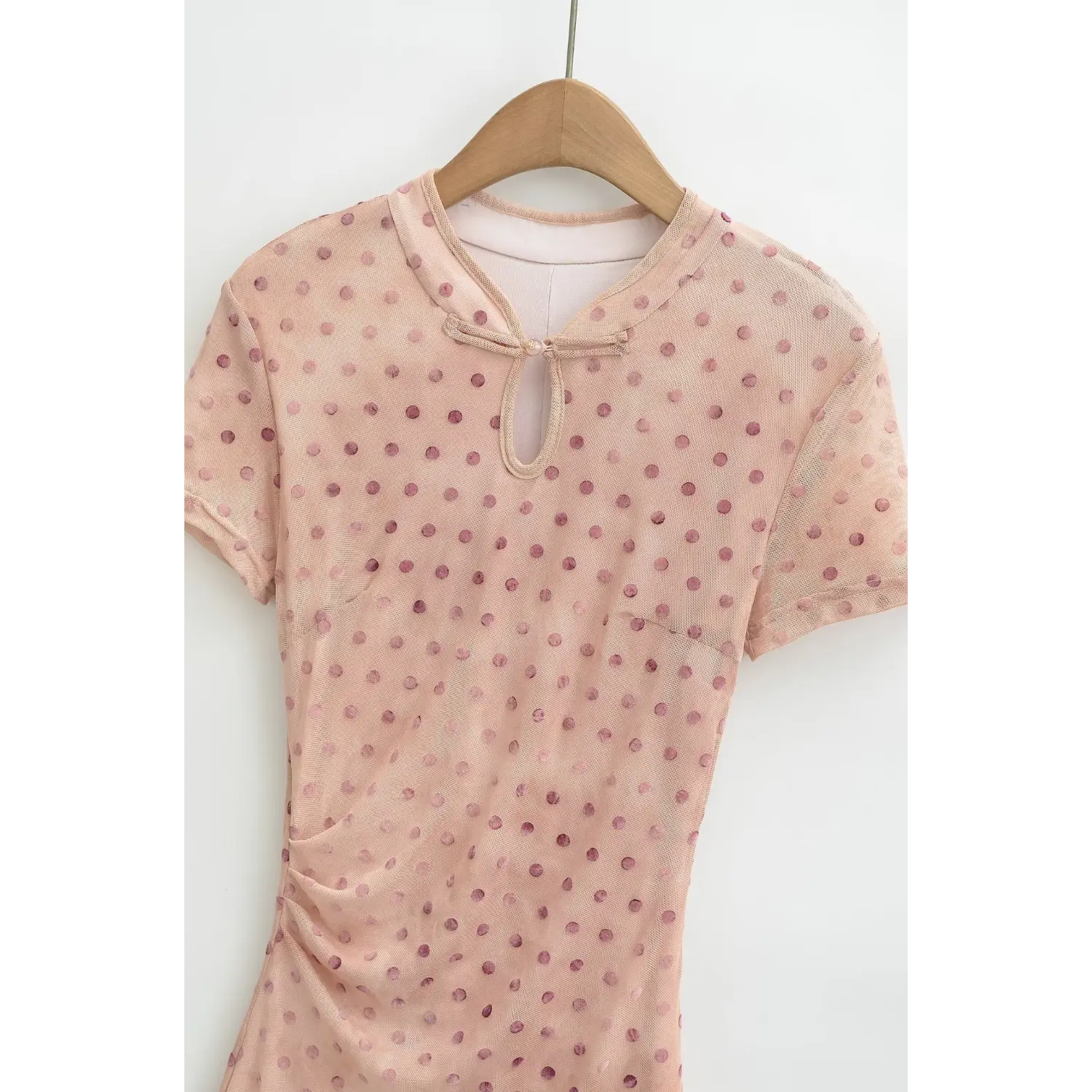 Hanger front close‑up of keyhole neck and short sleeve, nude pink polka dot maxi dress