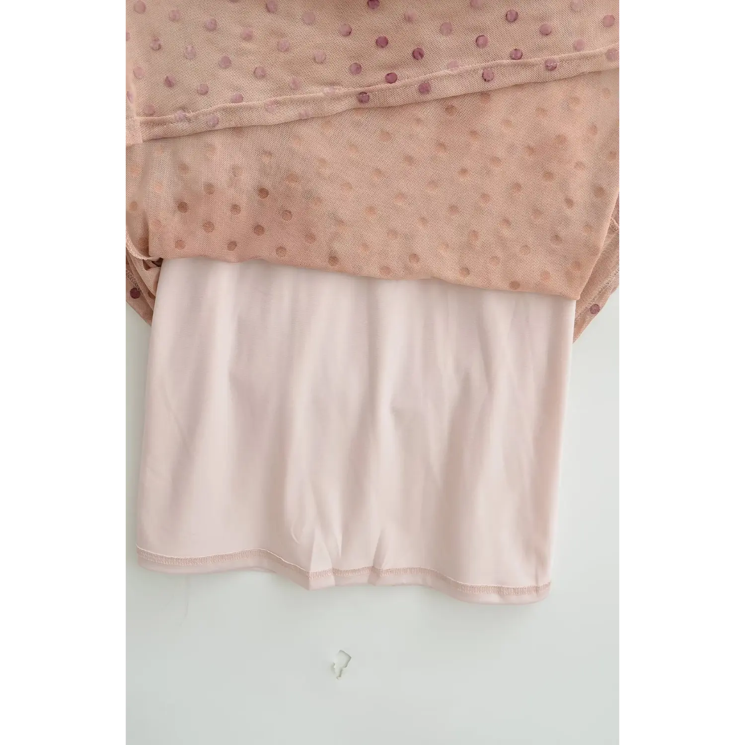 Close‑up of inner lining of nude pink polka dot cheongsam‑style maxi dress