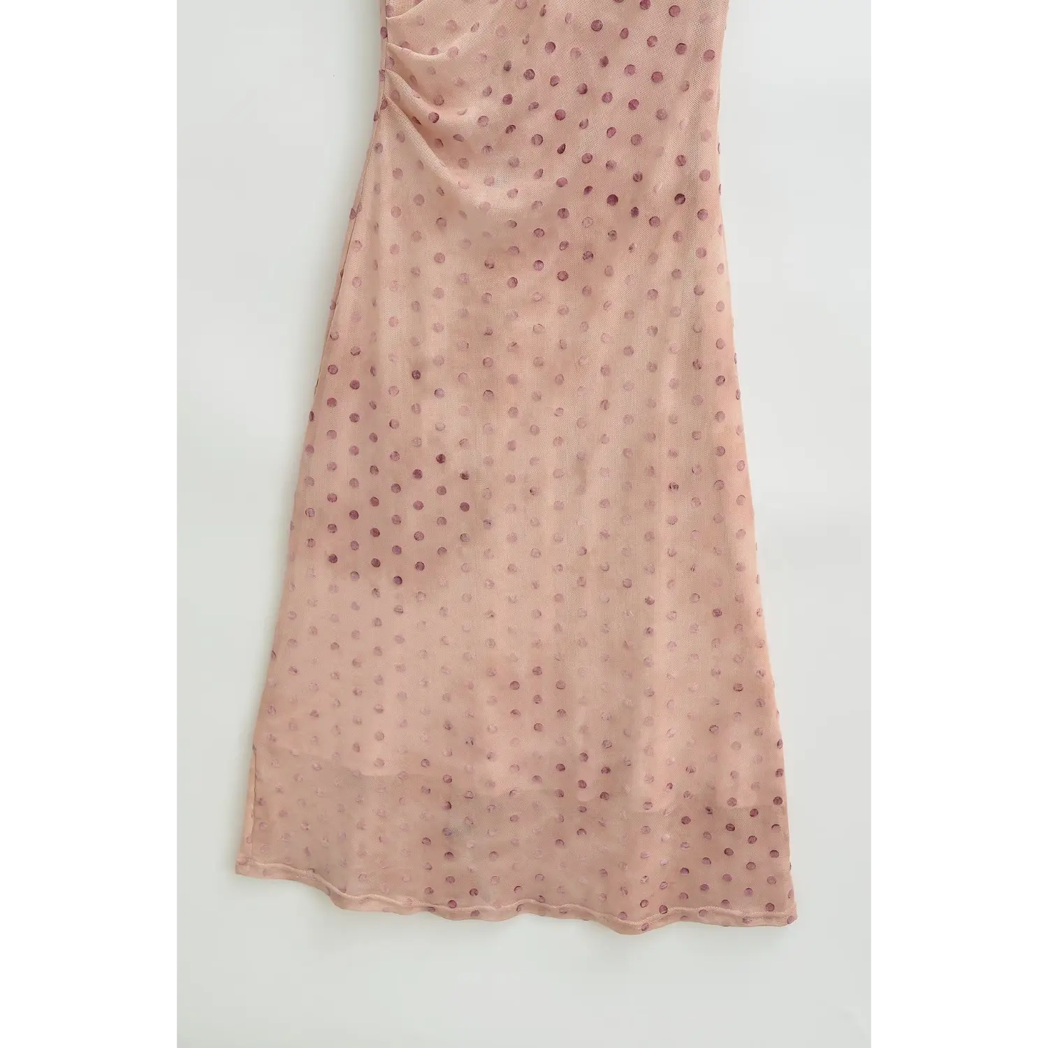 Full view of lace scalloped hem on nude pink polka dot cheongsam‑style maxi dress