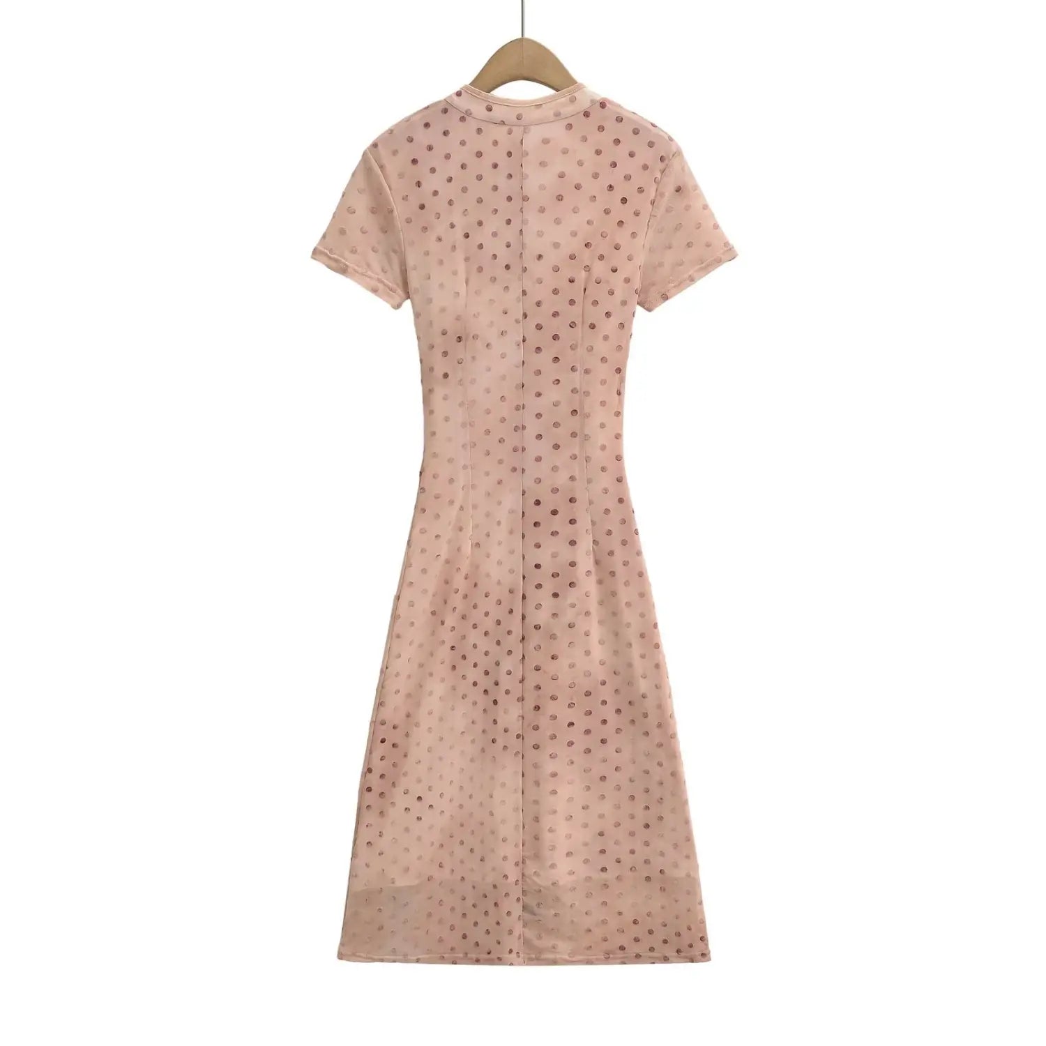 Nude pink polka dot cheongsam‑style maxi dress hanging on wooden hanger, back view