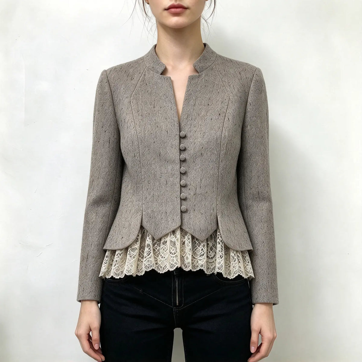Model wearing oatmeal stand collar button front lace hem jacket, front view