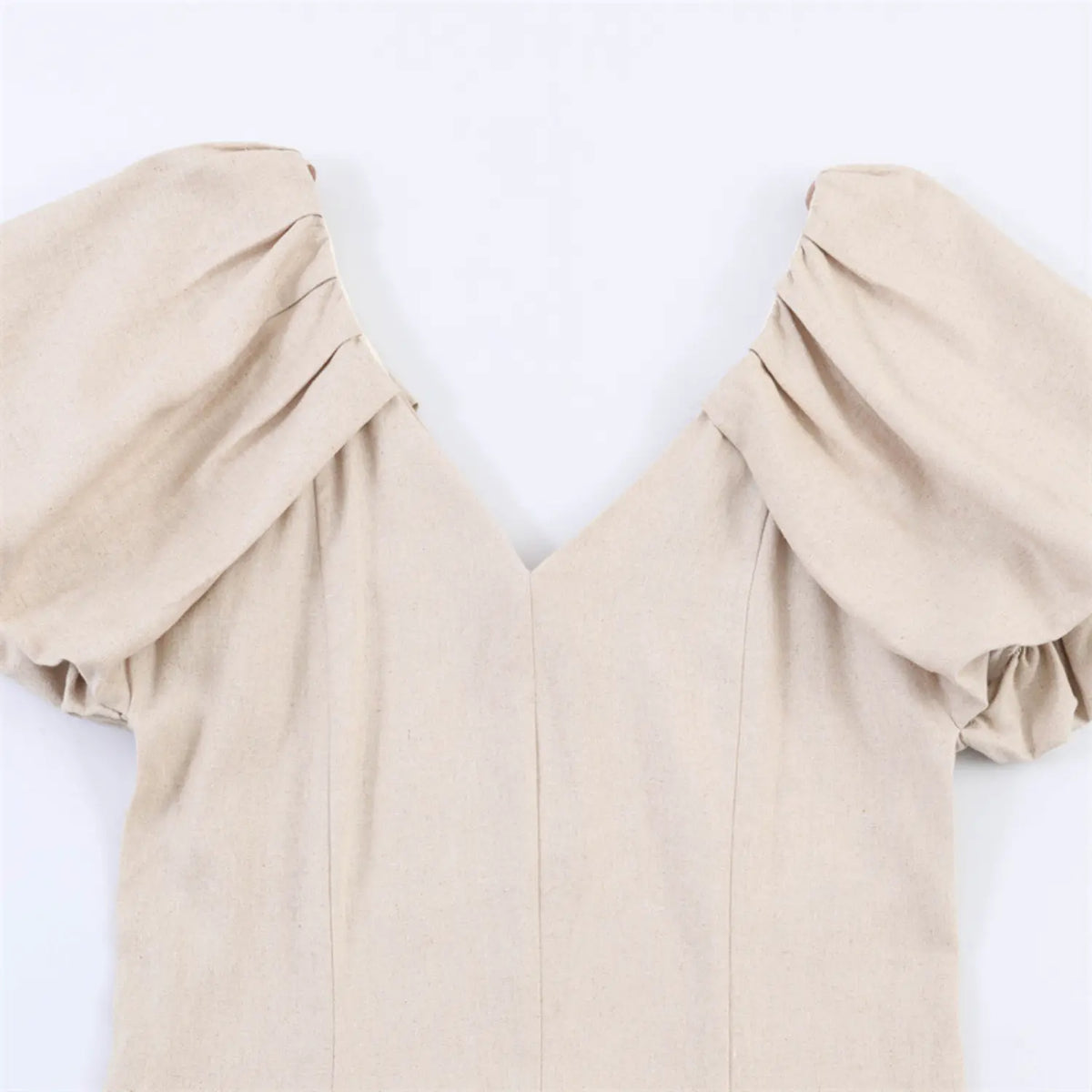 Close-up of V neck and puff sleeve shoulder