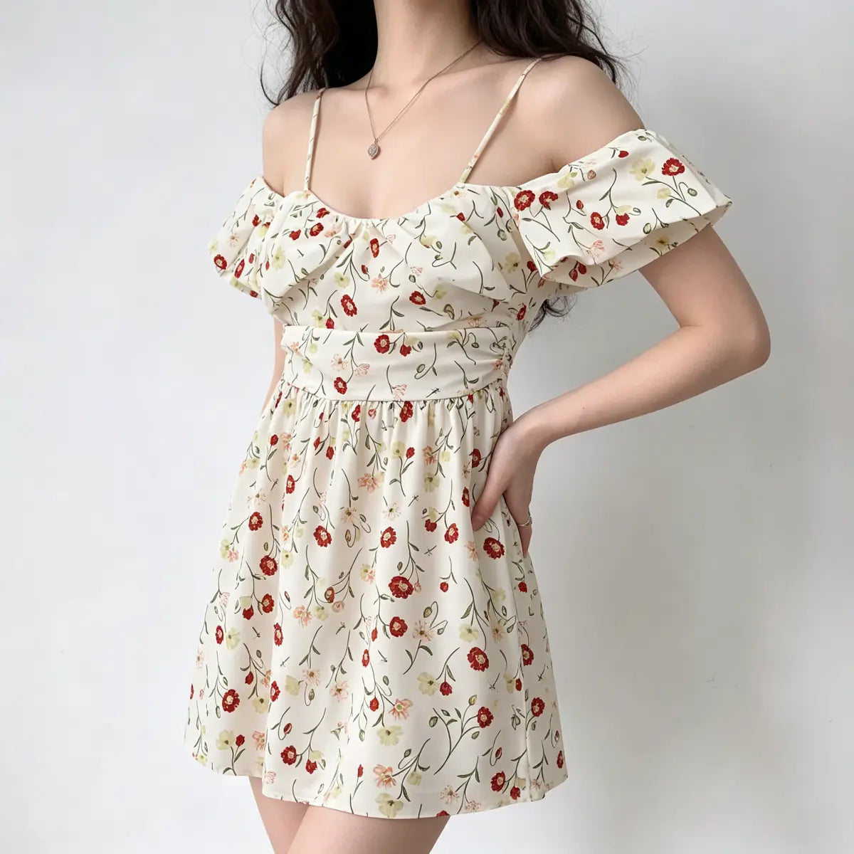 Three-quarter view of a model wearing an off-shoulder floral dress, with a heart-shaped bag in hand.