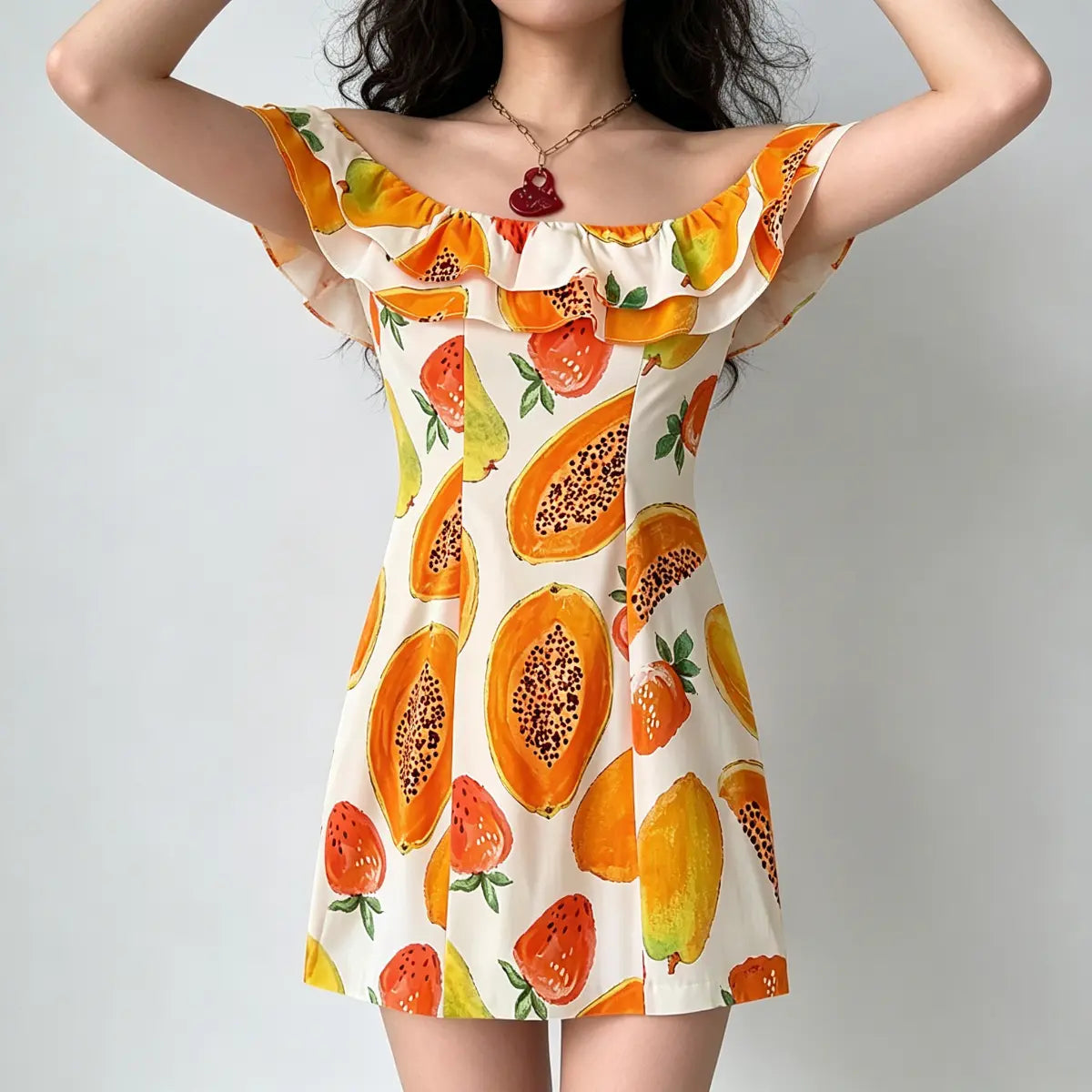 Full front view of off-shoulder fruit print mini dress, featuring a ruffled neckline and fitted waist.