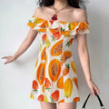 Model wearing off-shoulder fruit print mini dress, styled with a black bag for casual summer look.