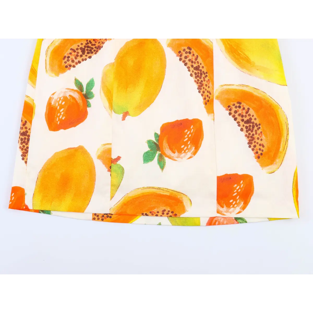 Close-up of the skirt hem on fruit print off-shoulder dress, showing neat stitching and panel seams