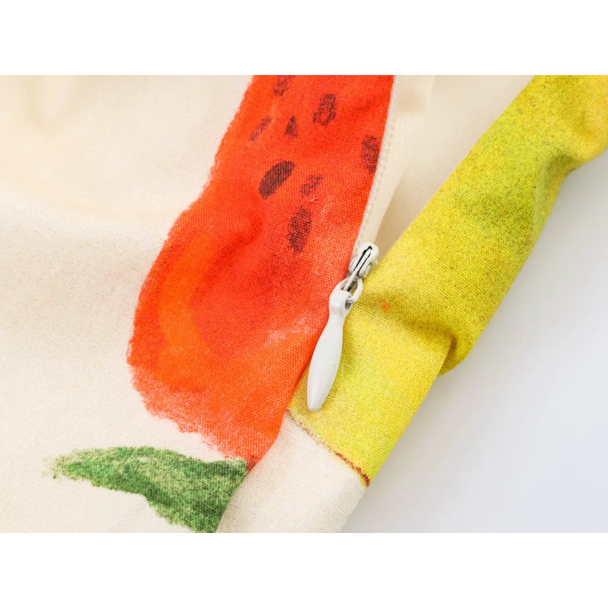 Close-up of side zipper detail on off-shoulder fruit print dress, showing white zipper pull and fabric print.