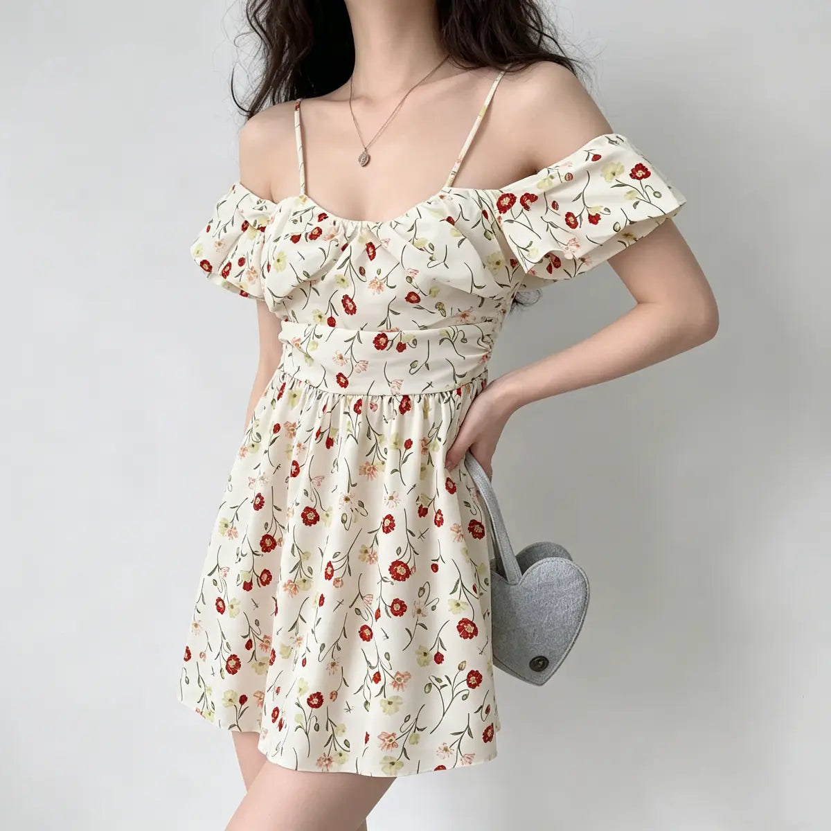 Profile view of a model wearing an off-shoulder poppy-print mini dress, showing the puff sleeve detail.