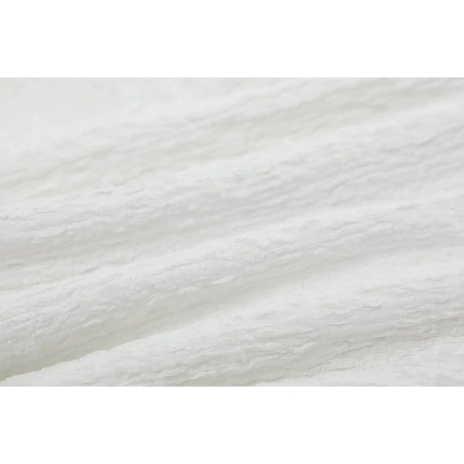 Macro texture shot of off-white crinkled bubble fabric showing its unique wrinkled surface