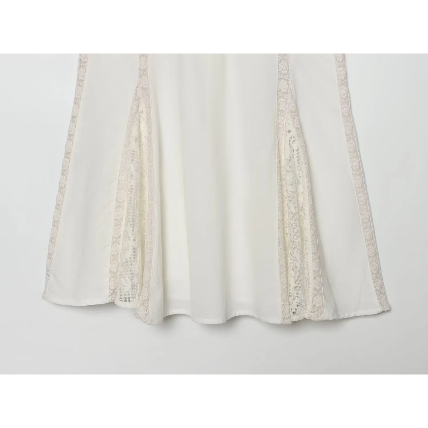 Partial shot of flared skirt with lace side panels for off‑white vintage mini dress