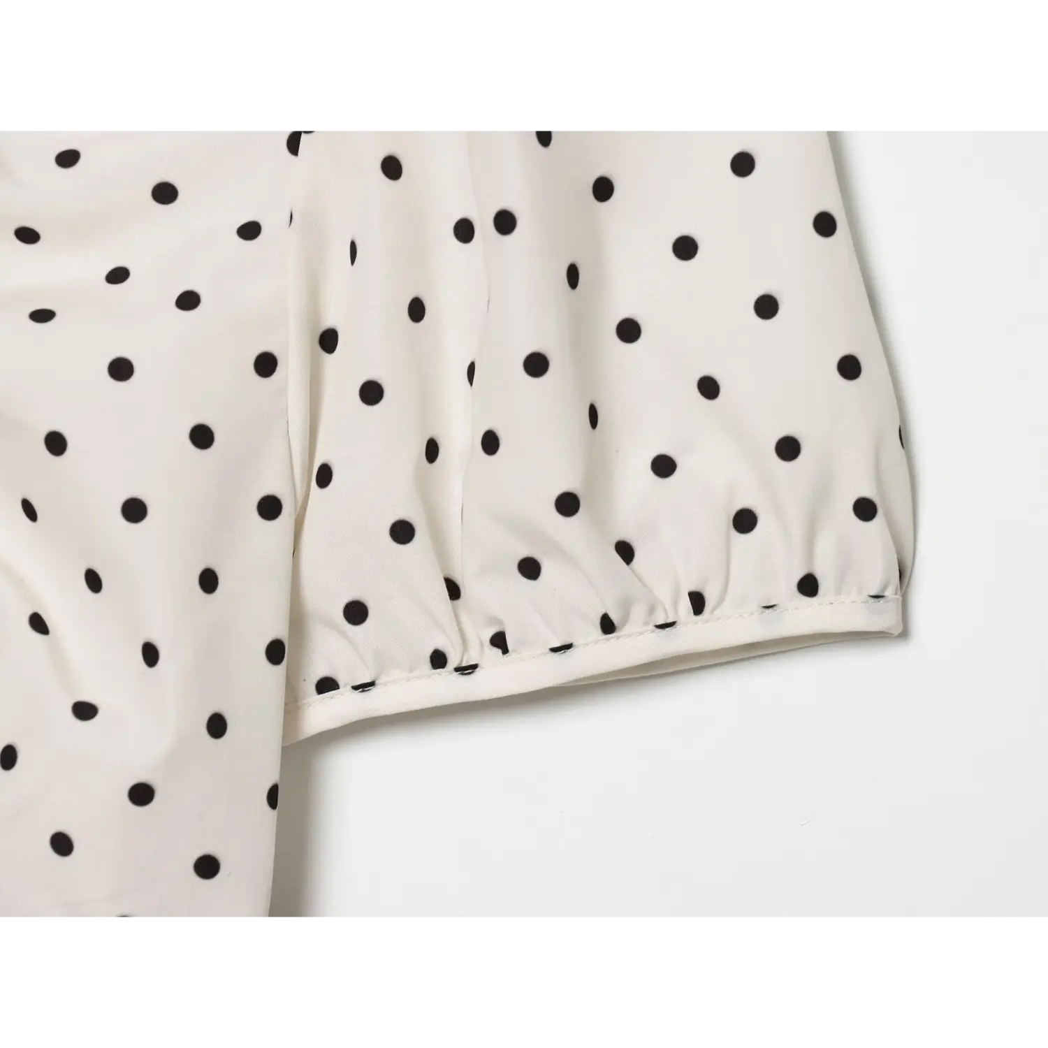 Detail elasticated bubble short sleeve hem, gathered cuff, off-white black dot print fabric