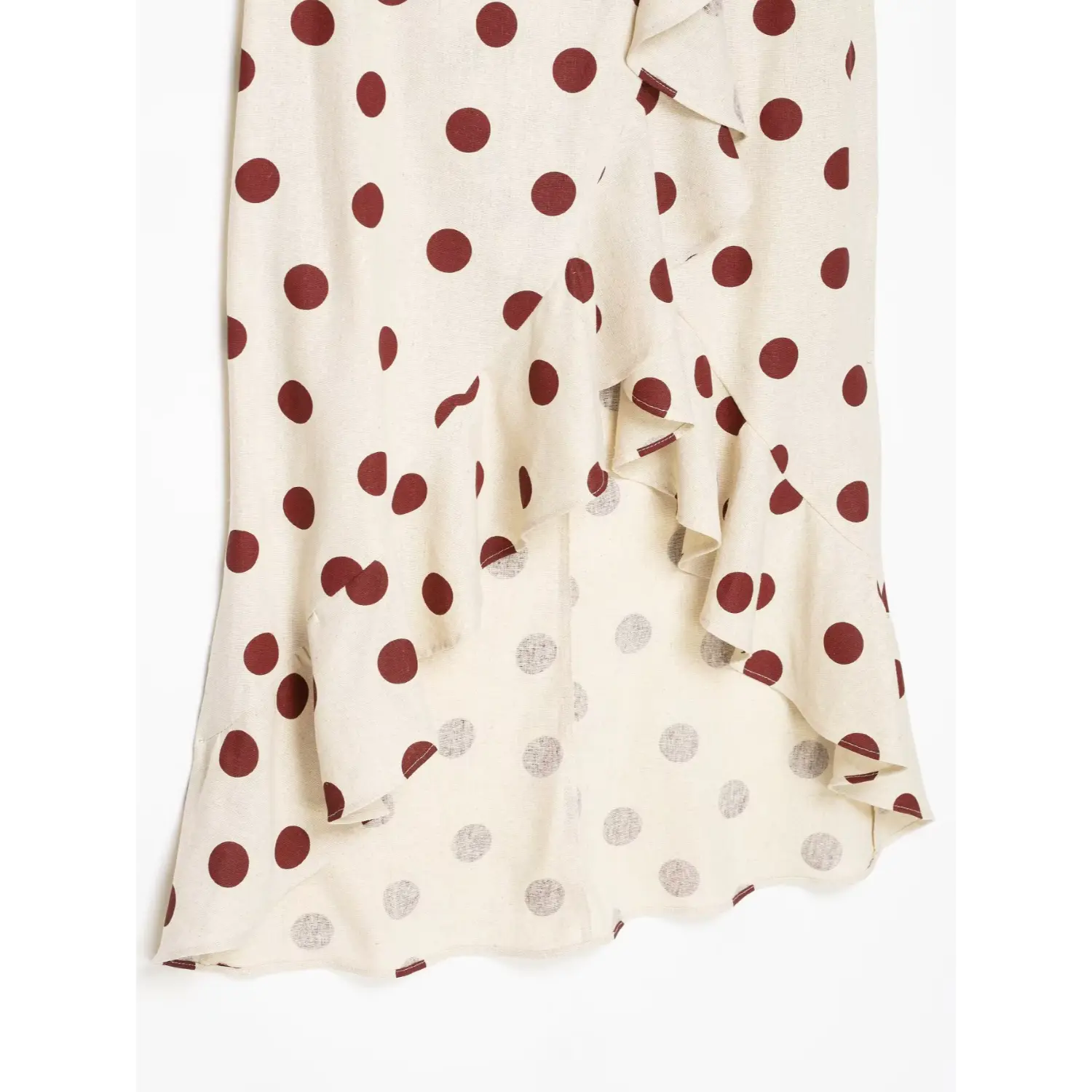 Close-up detail of asymmetrical layered ruffle wrap hem on off-white wine dot linen midi dress