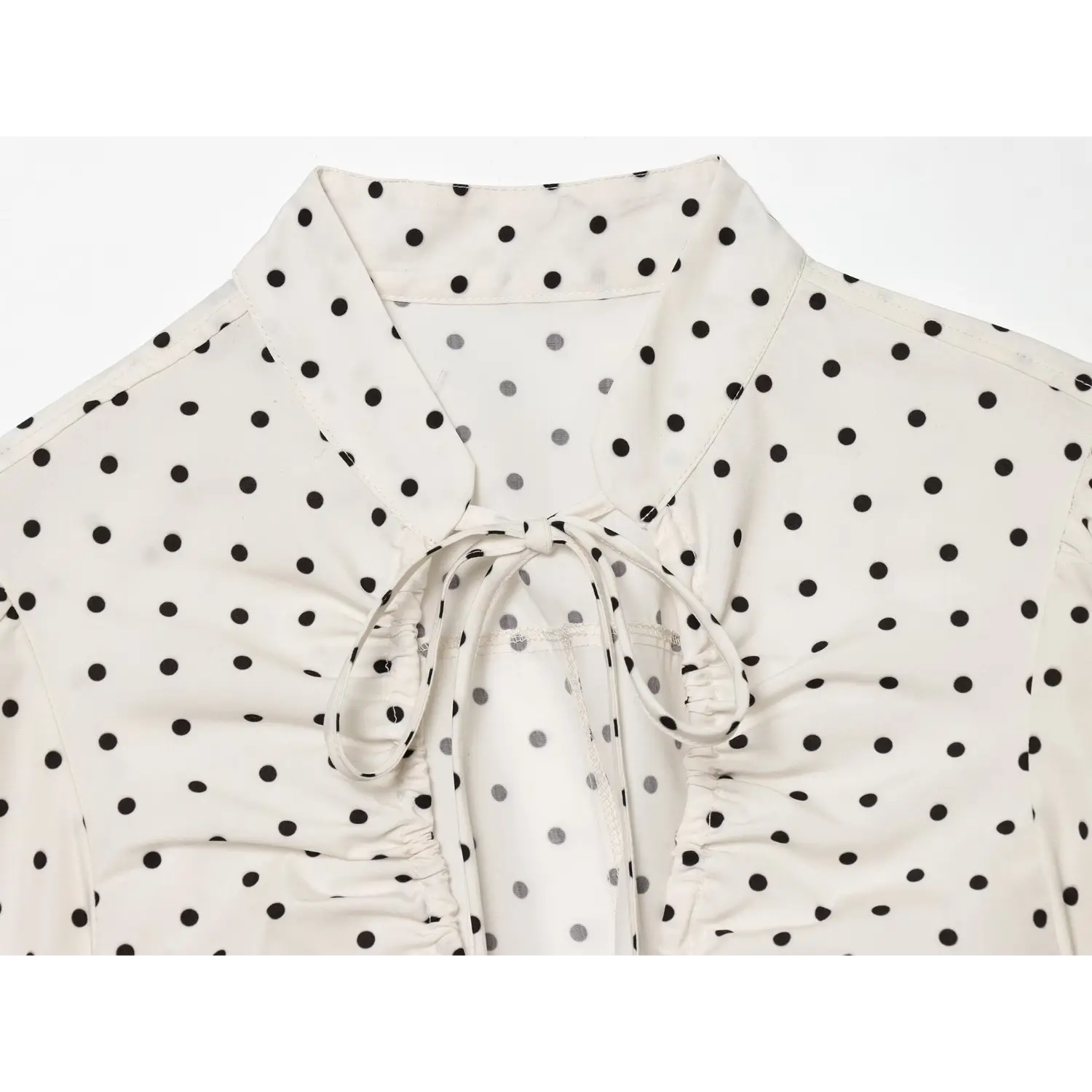 Closeup tie v neckline, self fabric neck tie, front bust shirred ruched design, stand collar polka dot woven shirt