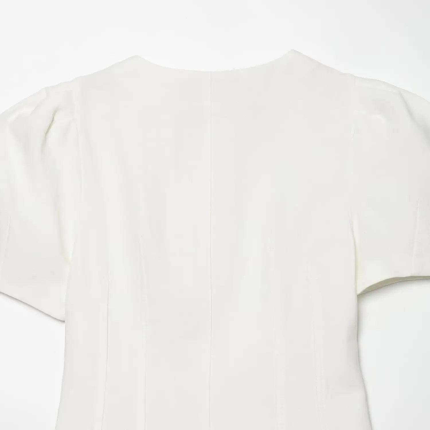 Close-up of the back panel and vertical seams on the off-white puff sleeve mini dress