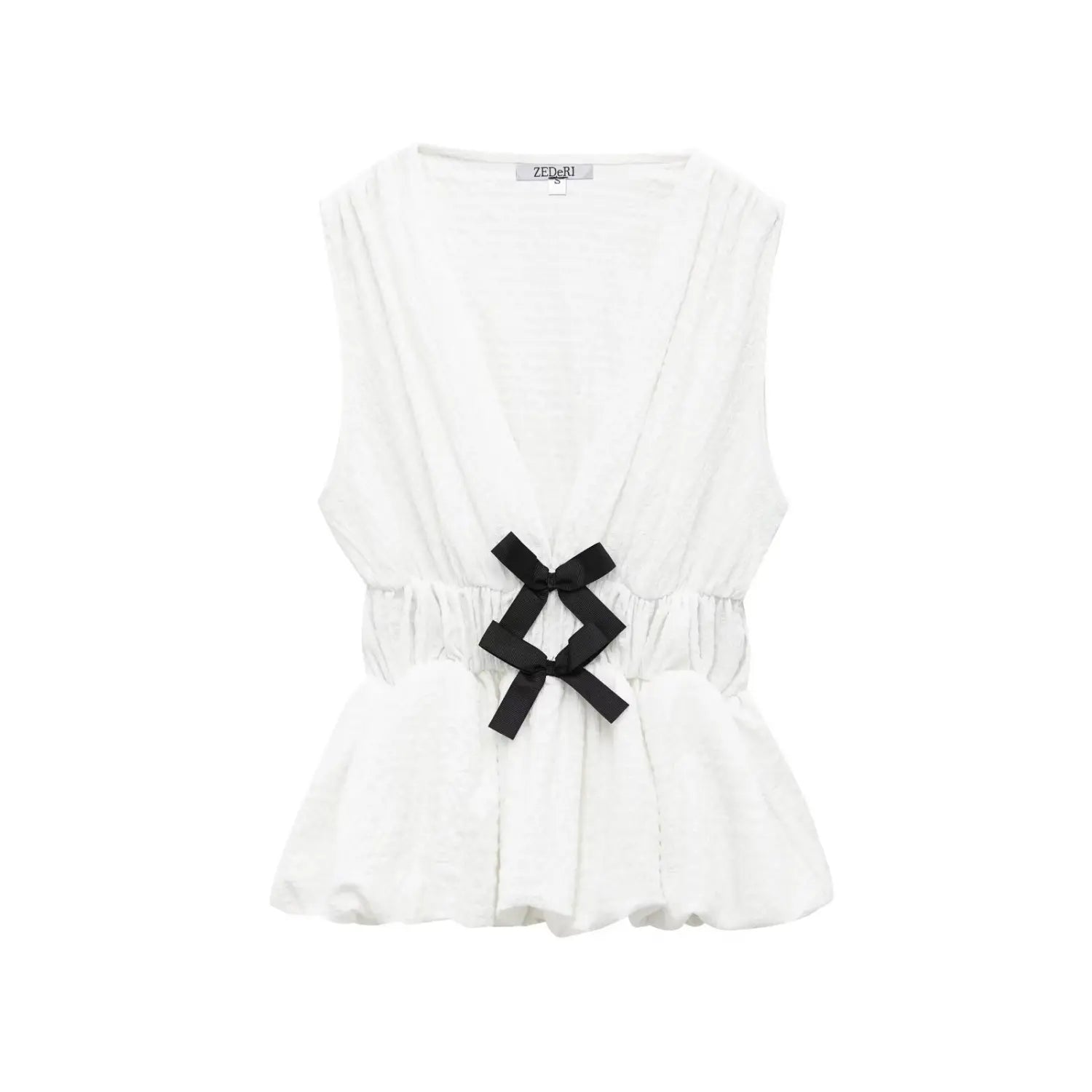 Full front view on white background of off-white crinkled fabric peplum top with black bows
