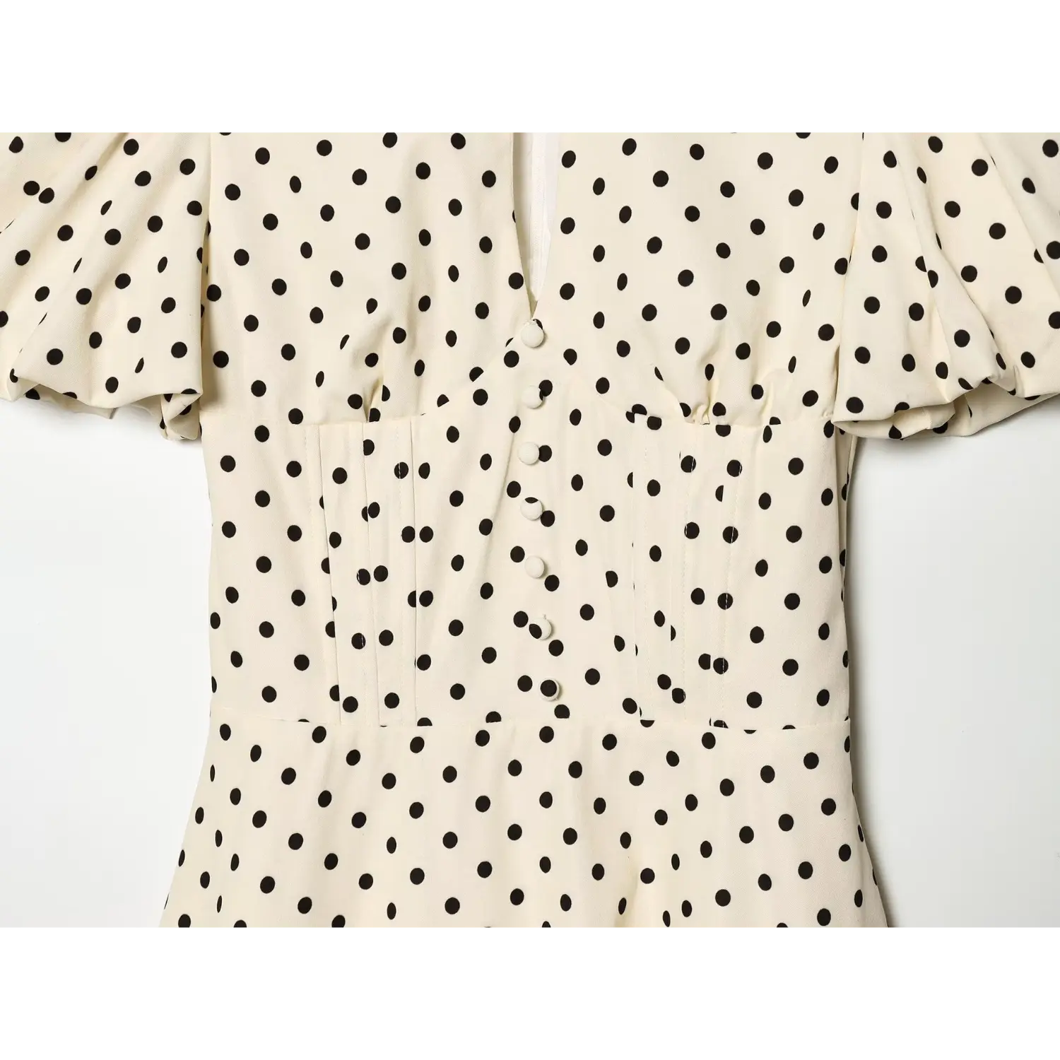Off‑white black polka dot dress bodice close‑up,faux front buttons,pleated waist stitching