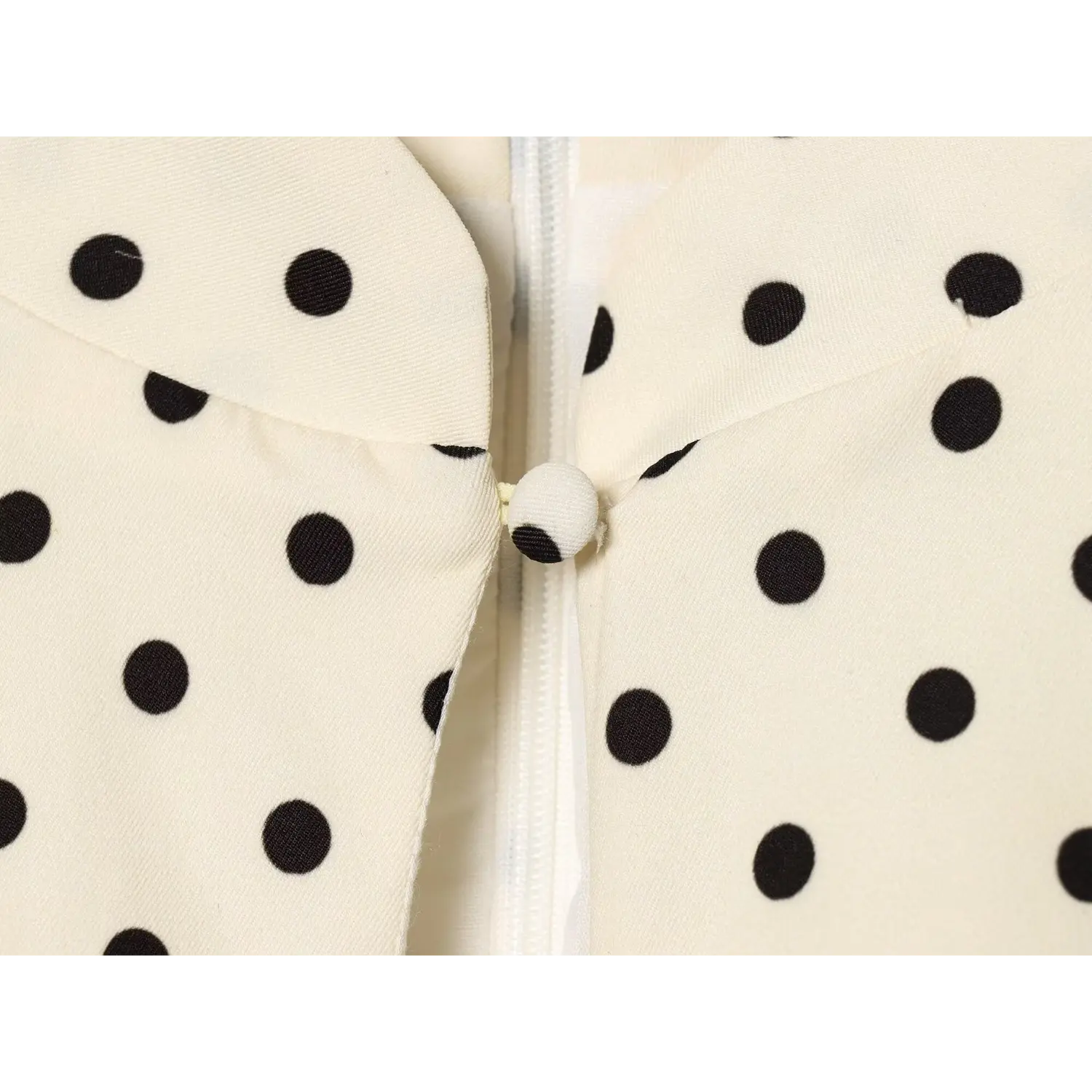Off‑white black polka dot dress fabric covered decorative button macro detail
