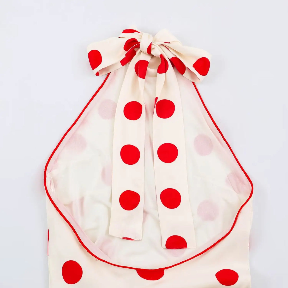 Inner view of halter neck with red piping and polka dot print