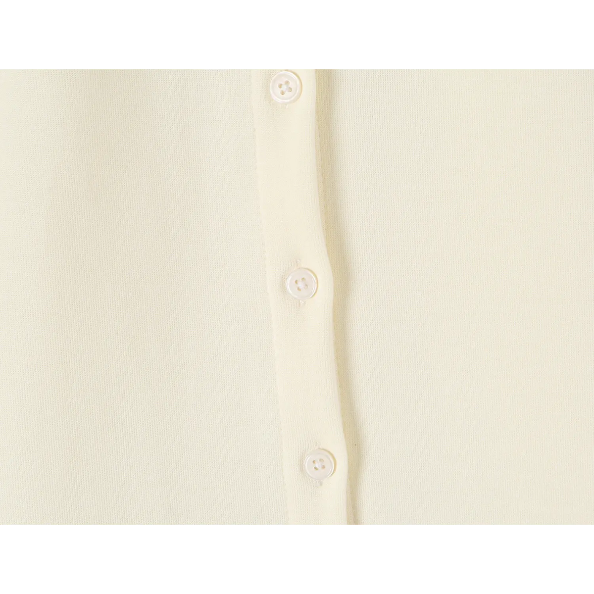Macro detail of offwhite dress front button placket, round white buttons and soft fabric