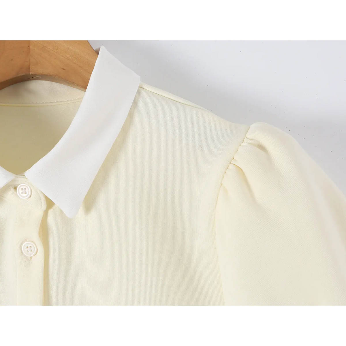 Close up shot of offwhite mini dress, white contrast collar, puff short sleeve and front button placket