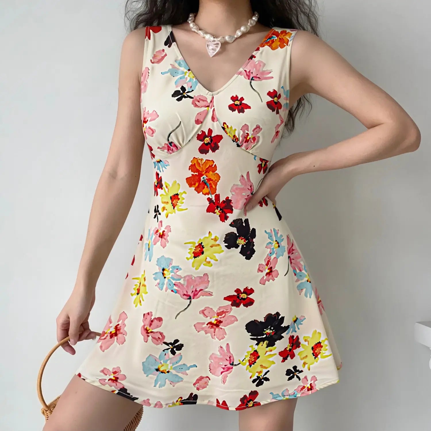 Oil painting floral mini dress model natural light wearing shot, V-neck flatter collarbone drawstring highlight waist A-line swing hem hide hip summer vacation feminine outfit display
