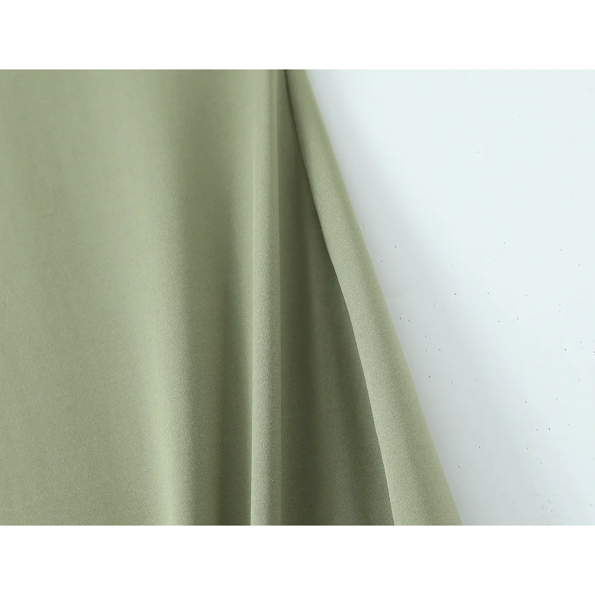 Close-up of the olive green fabric showing its smooth drape and texture.