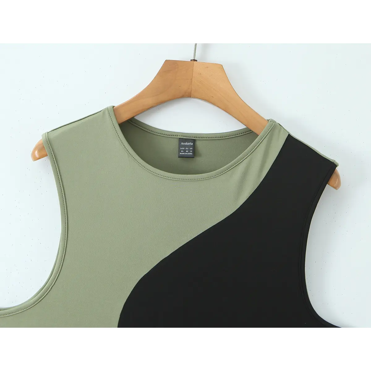 Close-up front view of the tank top, showing the neckline, brand label, and diagonal olive-black colorblock design.