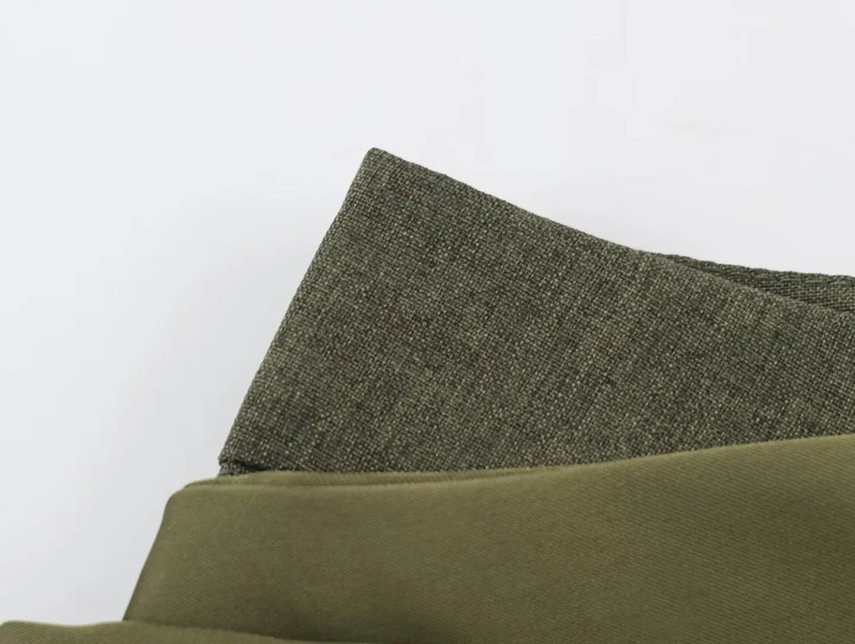 Macro close-up of olive green suiting fabric texture