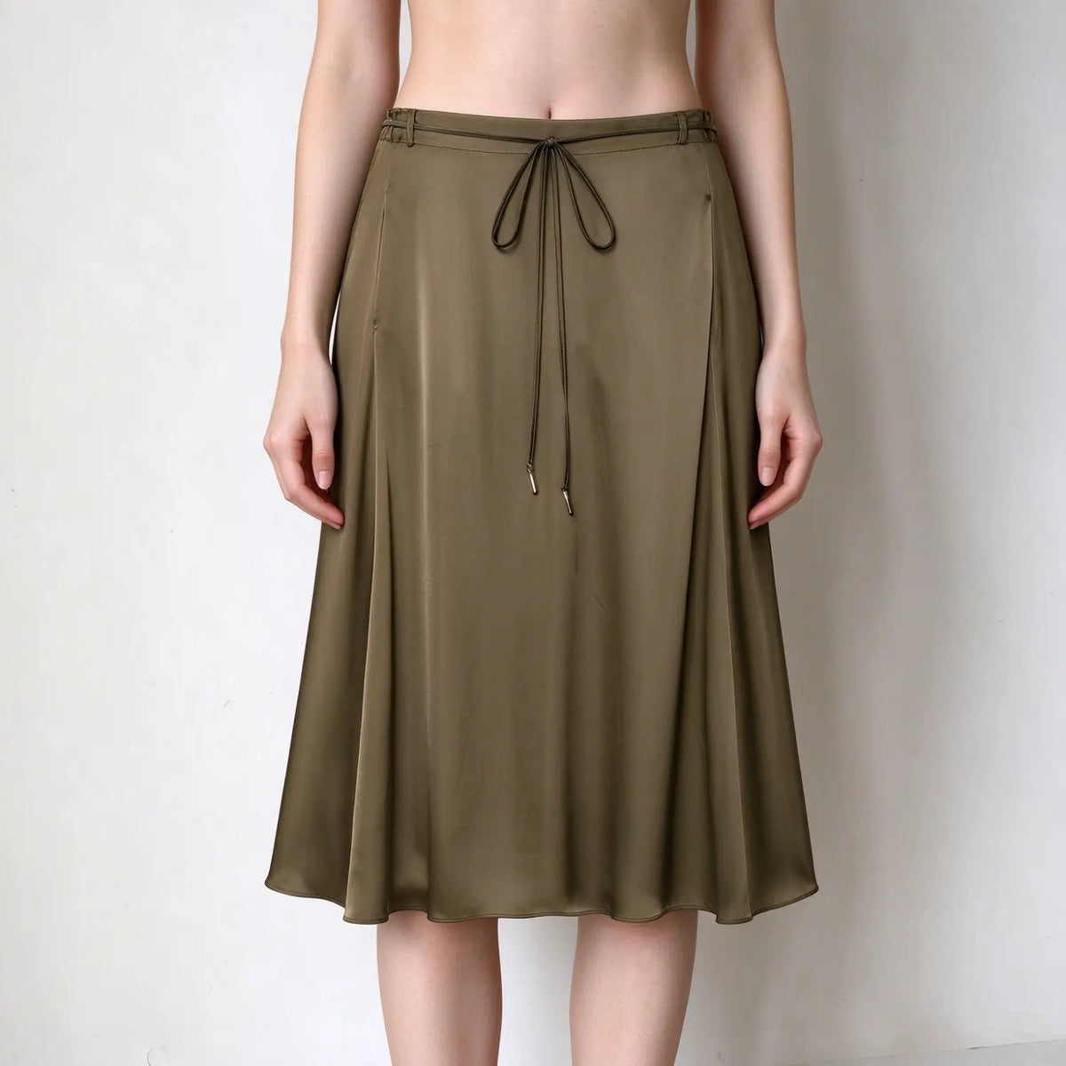 Model wearing olive drawstring satin A-line midi skirt, front view