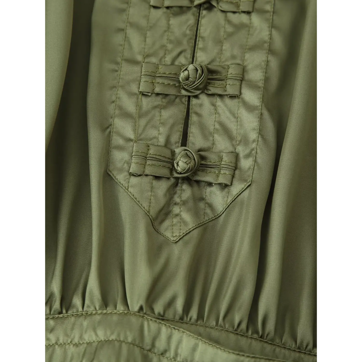 Close-up of frog button placket pointed hem