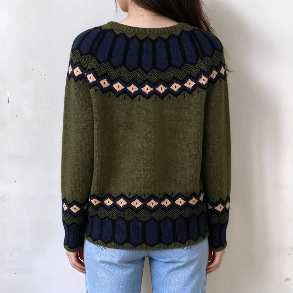 Female model back view, olive green fairisle knit sweater, navy and peach diamond jacquard on yoke and hem, long raglan
