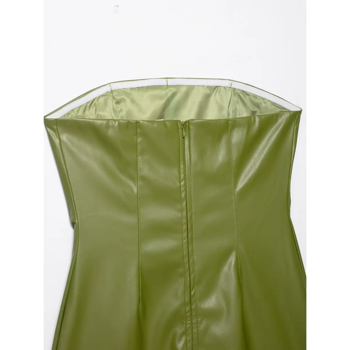 Close-up view of the back neckline on an olive green faux-leather strapless dress, showing the elasticated top edge, satin lining, and center zipper.
