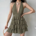 Model wearing olive green halter deep v neck layered ruffle mini dress