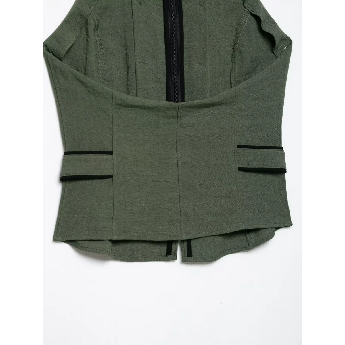 Back waist detail shot of olive green halter vest, structured panel stitching, black piping trim