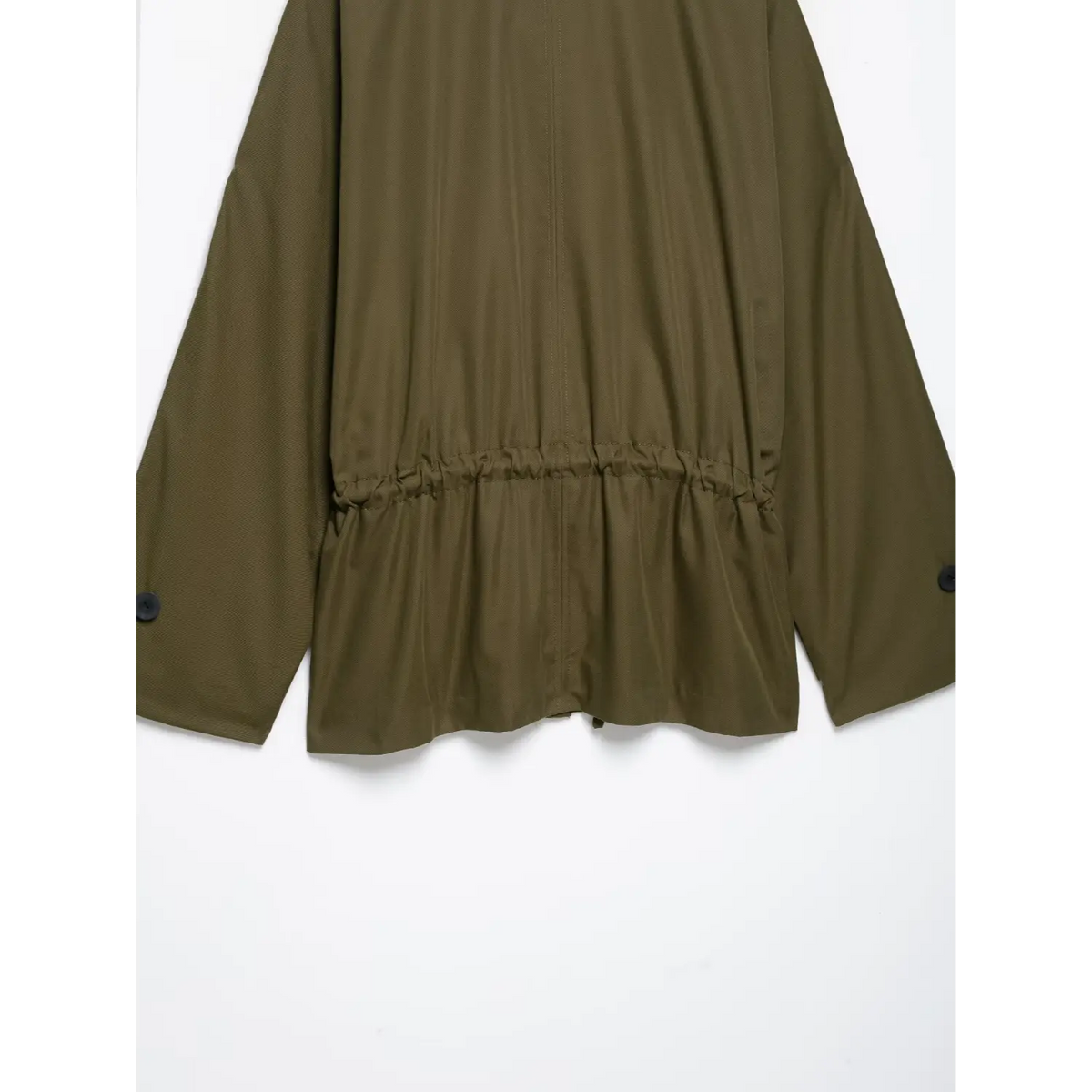 Close-up of gathered back waist and cuffs on olive green jacket