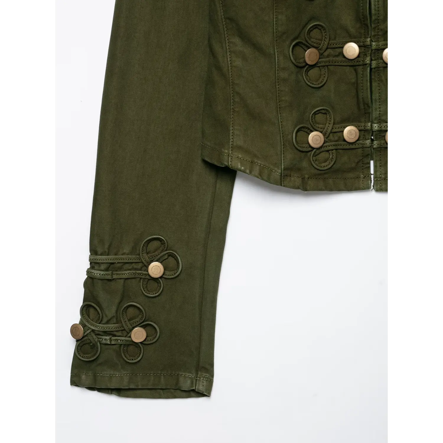 Close‑up of jacket sleeve cuff, ornate knot loop decoration with brass buttons, olive green washed twill fabric