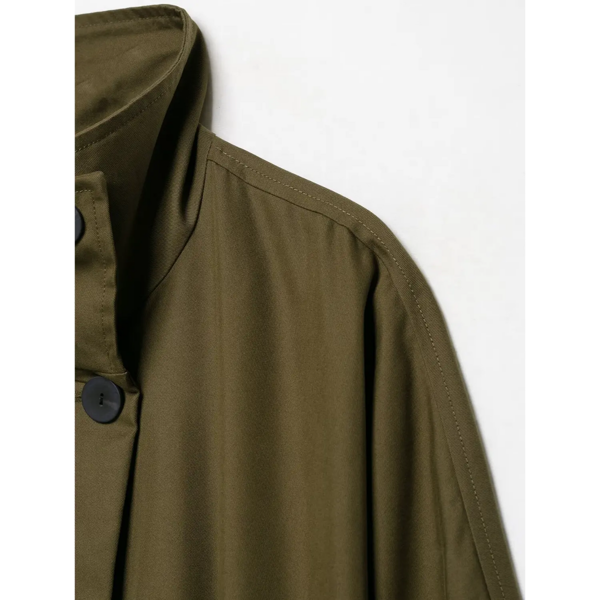Close-up of stand collar shoulder seam and stitching on olive green jacket