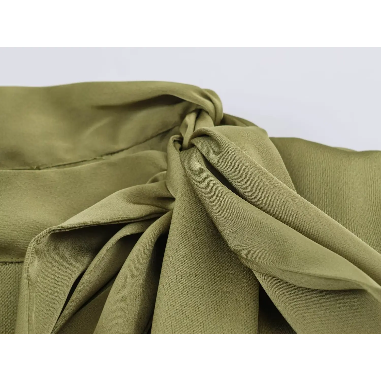 Detailed shot long hanging tie sash, soft drape of silky olive green textile