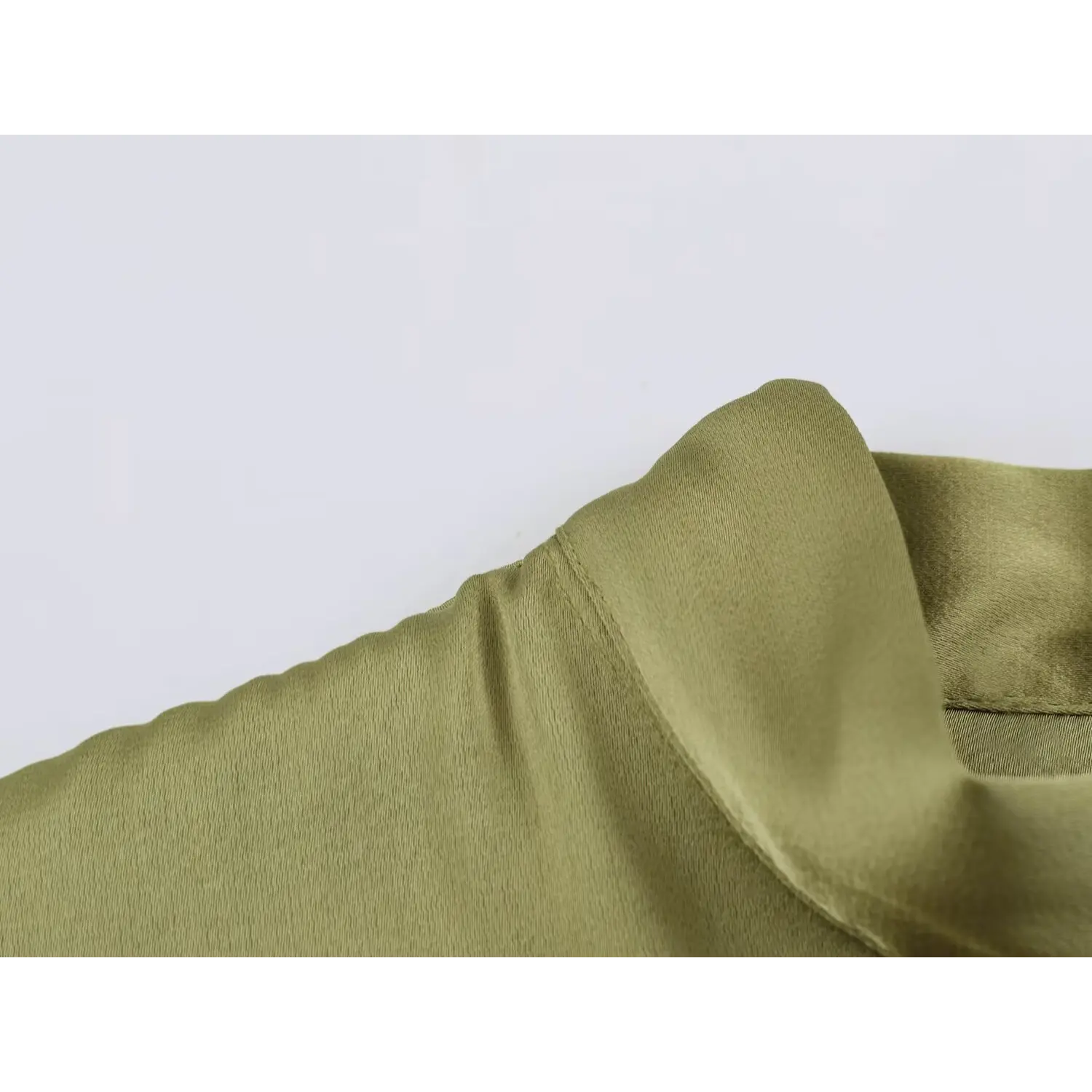 Neck closeup, smooth lightweight satin material weave, finished collar edge stitching