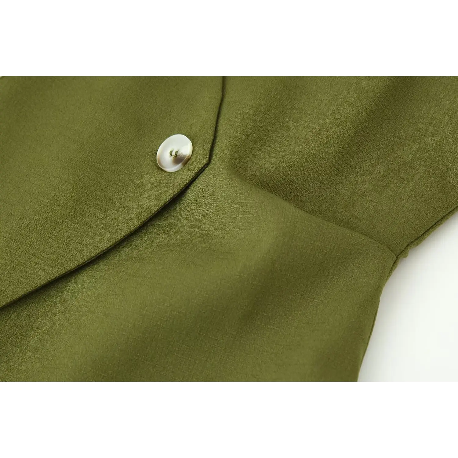 Front lapel & off-white shell button macro close-up, matte woven suiting fabric texture