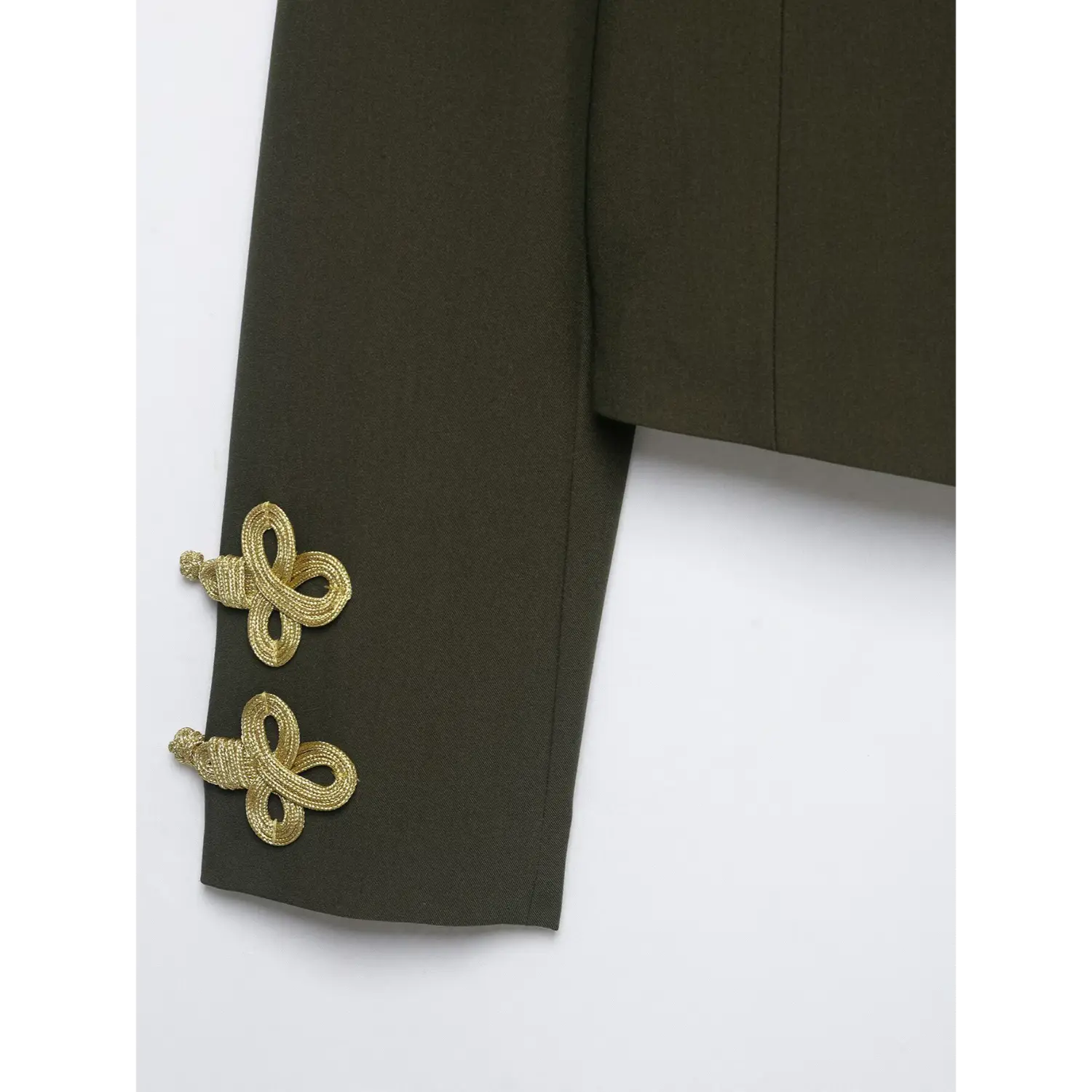 Close‑up of sleeve cuff gold decorative knot details on olive green cropped military blazer