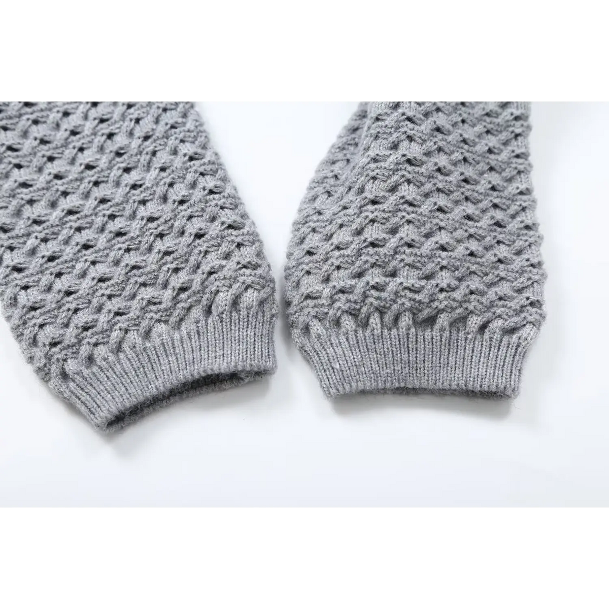 Close-up of gray openwork knit cuff