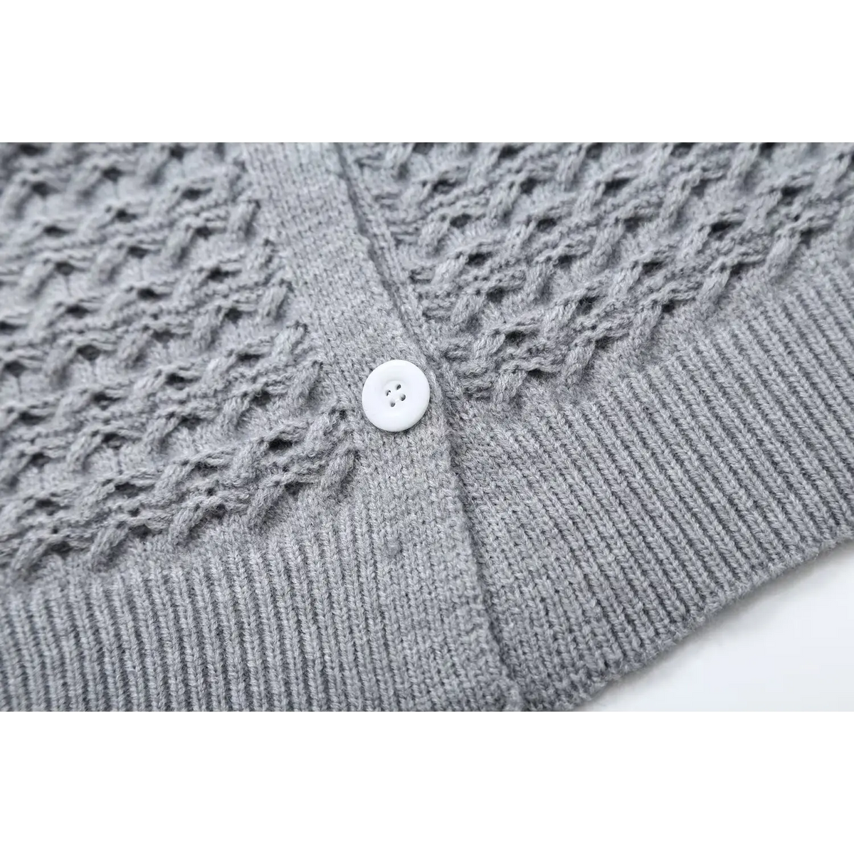 Close-up of gray button placket and ribbed hem