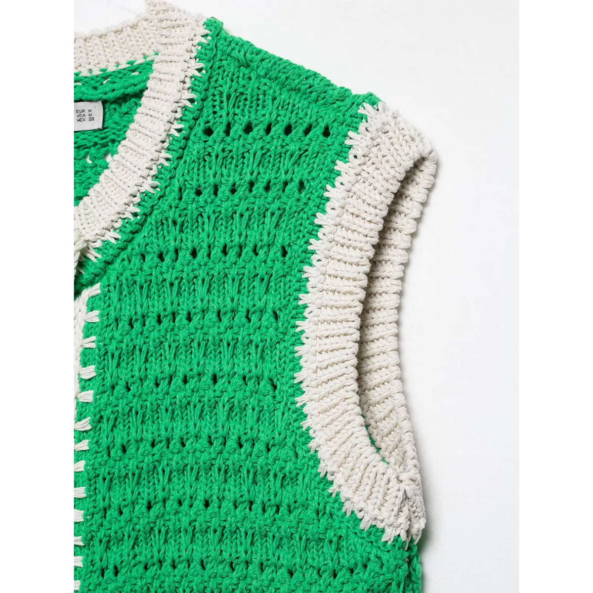 Close-up of green armhole contrast trim